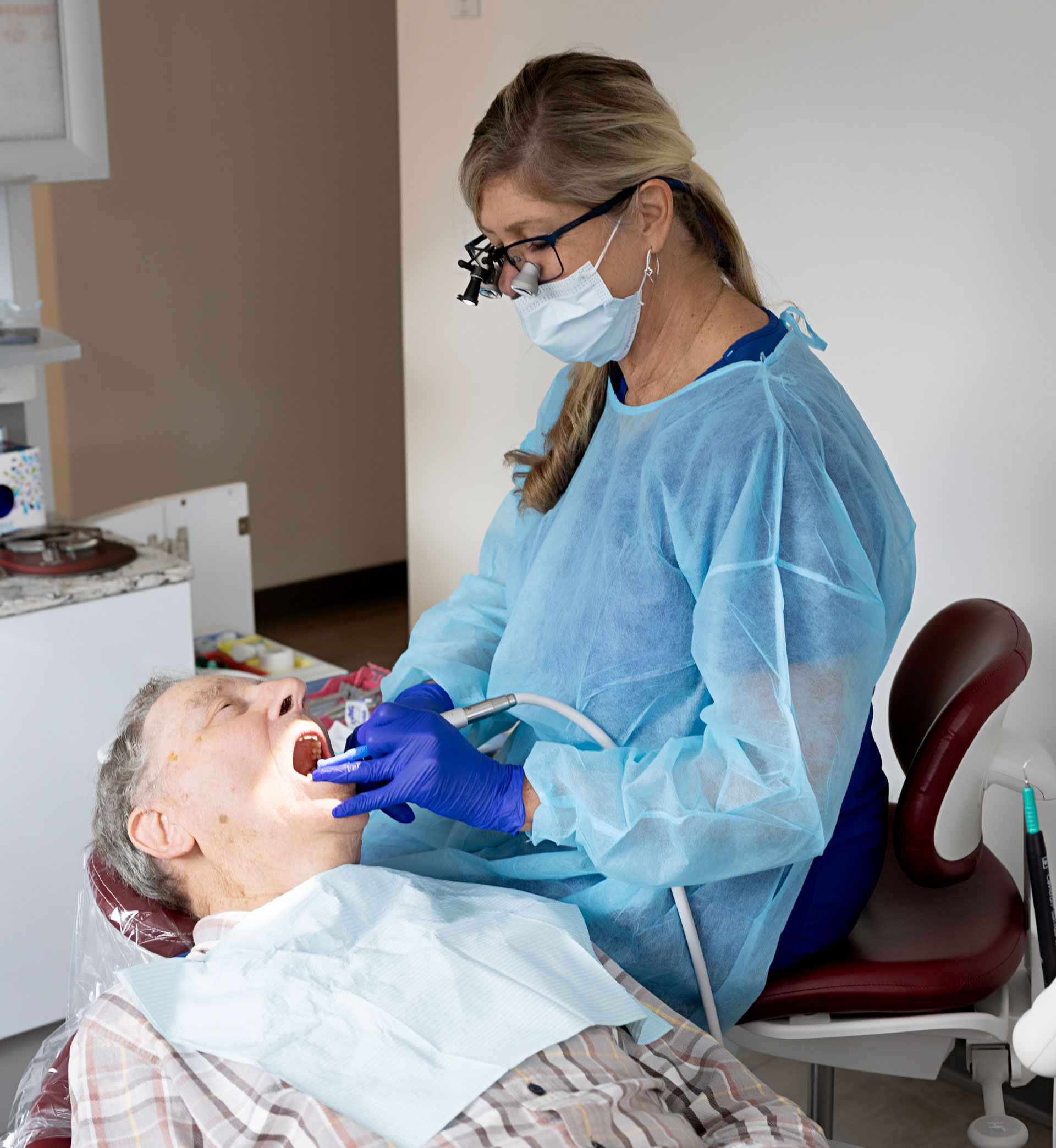 hygienist perfoming dental exam on patient