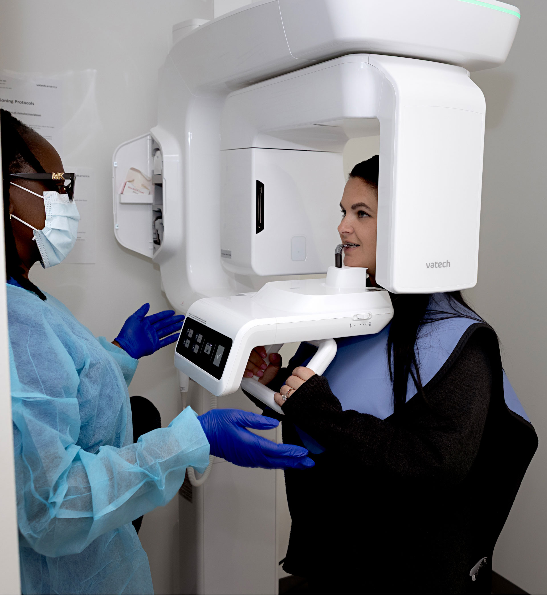 dental assistant taking dental xrays of patient