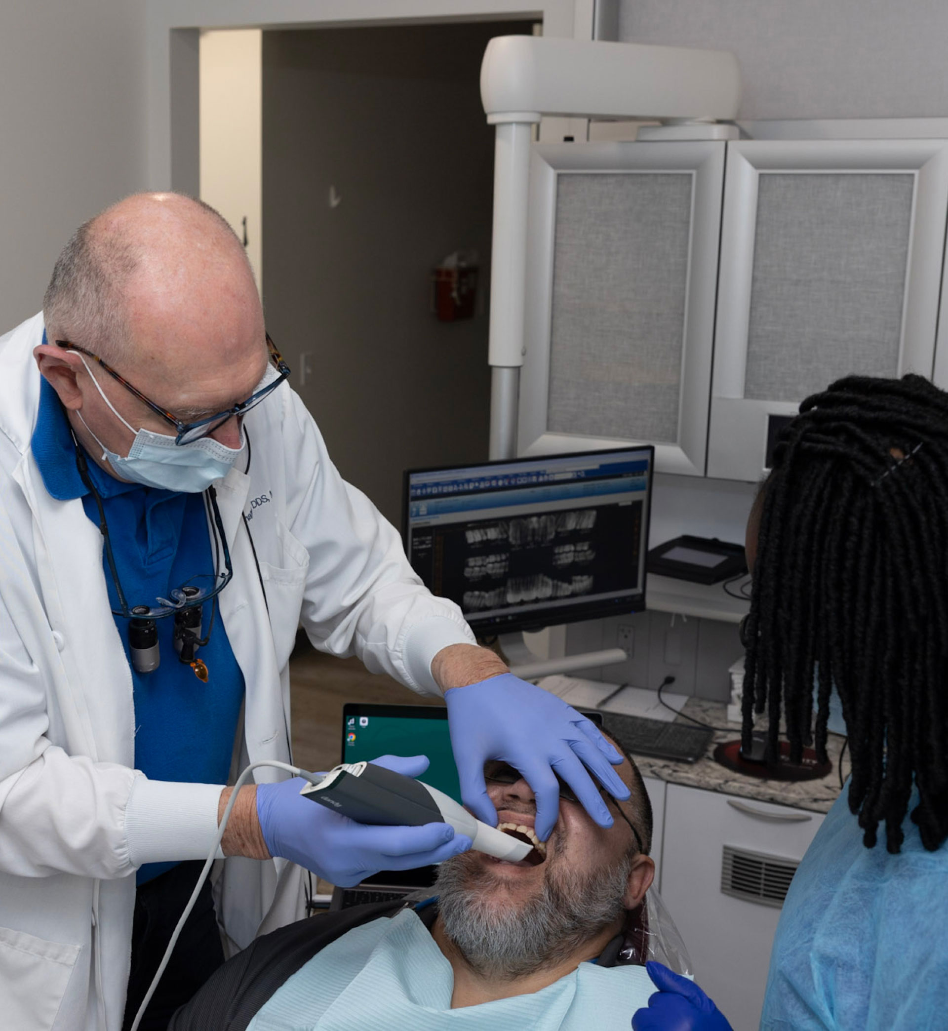 Dr. Flanagan and assistant performing dental exam on patient